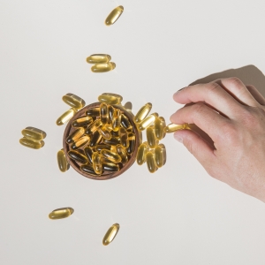 Hand holding vitamin capsules