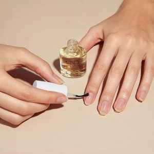 Close-up of nail oil application