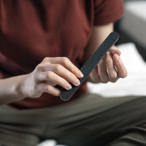 Woman filing her nails