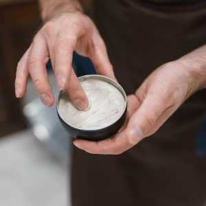 Man reaching for hair pomade